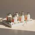 Six exact Sea Salt and Orchid mini mason jars on the spa surface